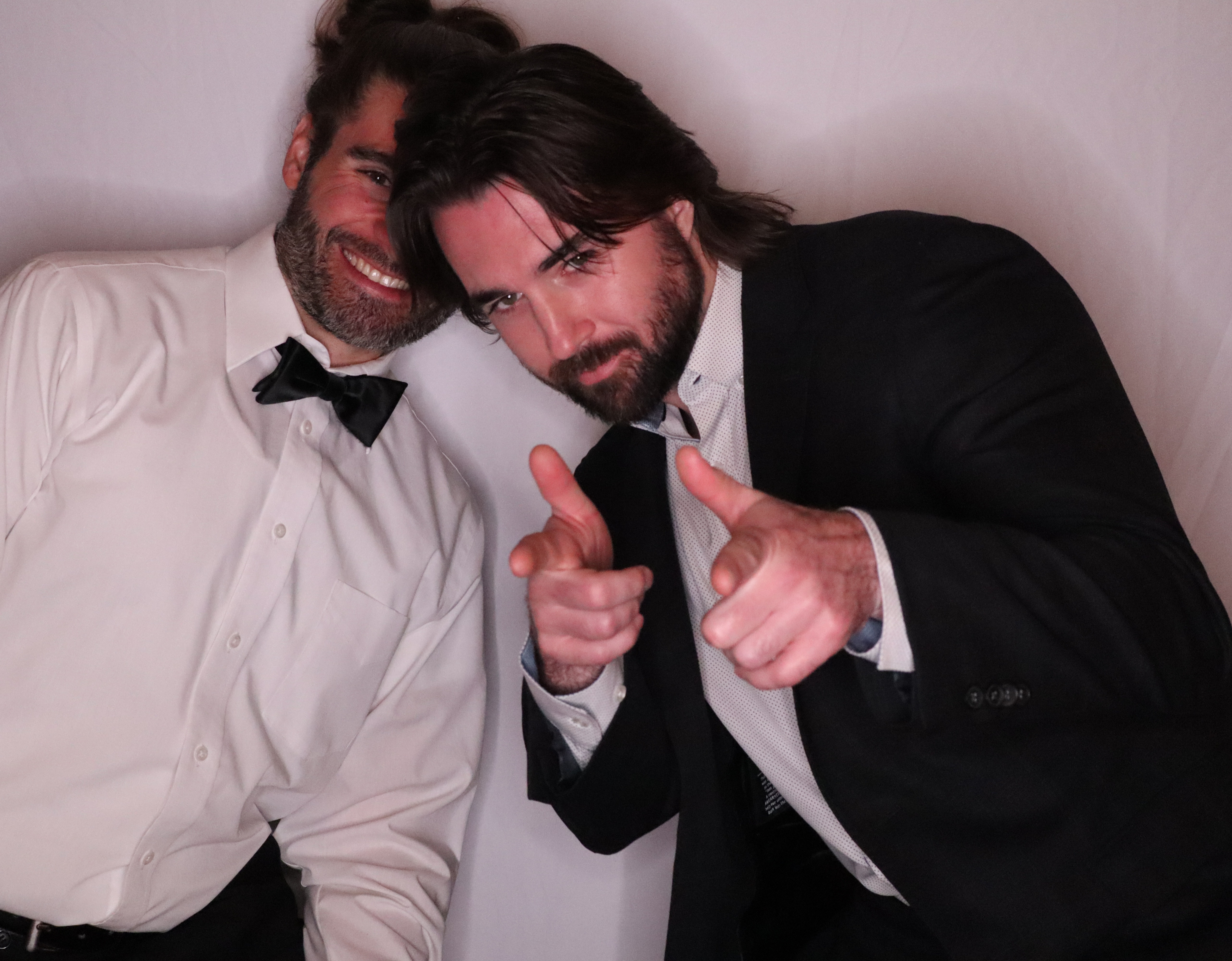 Wedding guests posing in tuxedos in the AIRi Photo Booth