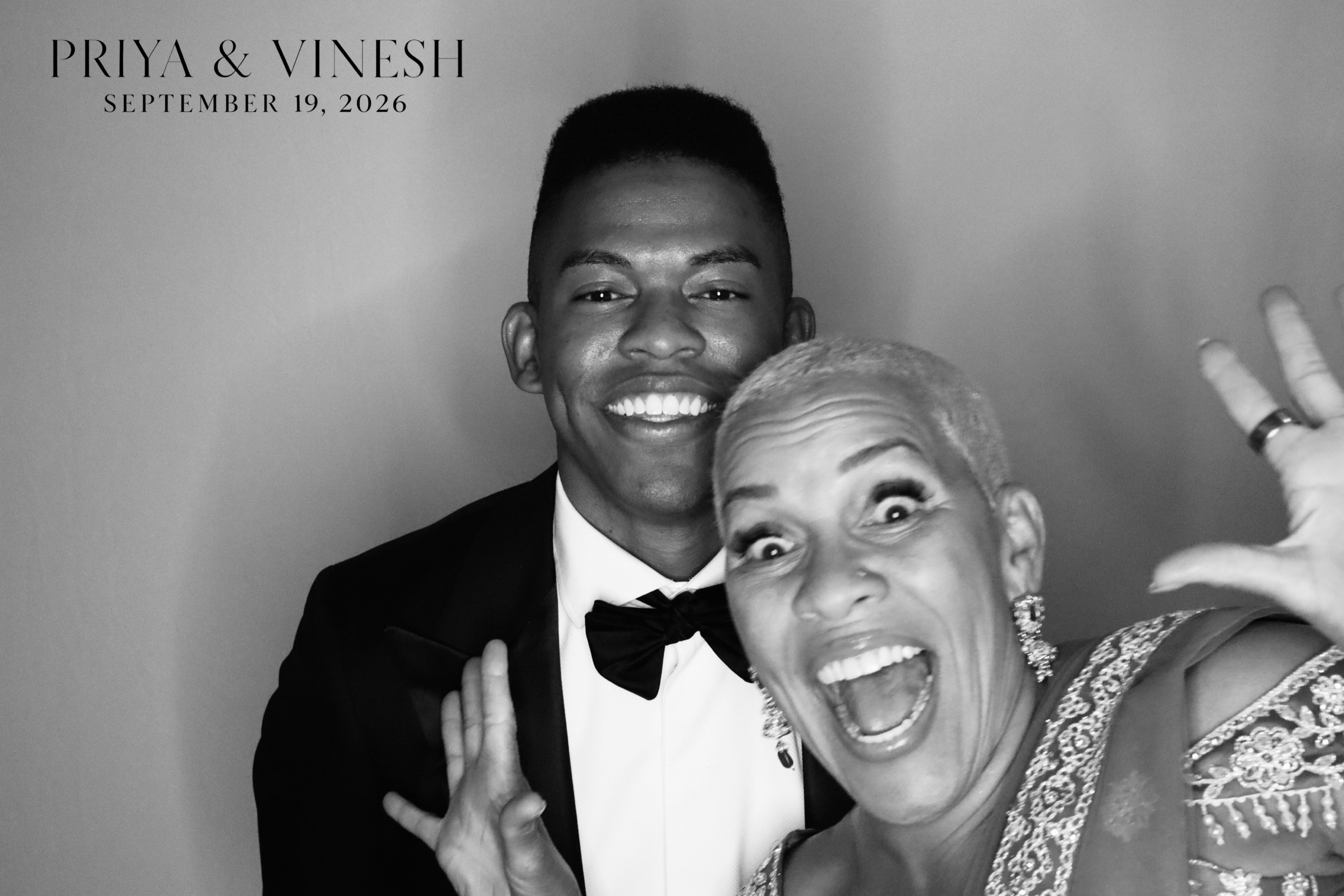 Guests laughing together in the AIRi Photo Booth at a Colorado wedding